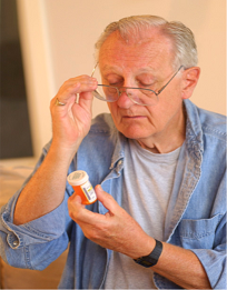 Picture of patient looking at prescription bottle